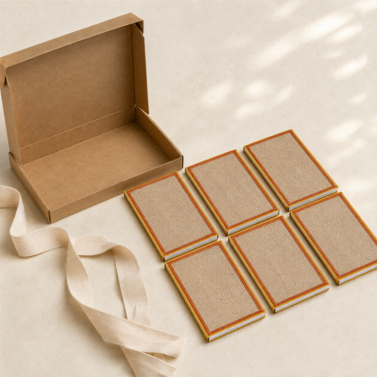 Six handcrafted jute notepads presented with a recycled kraft gift box and cotton ribbon
