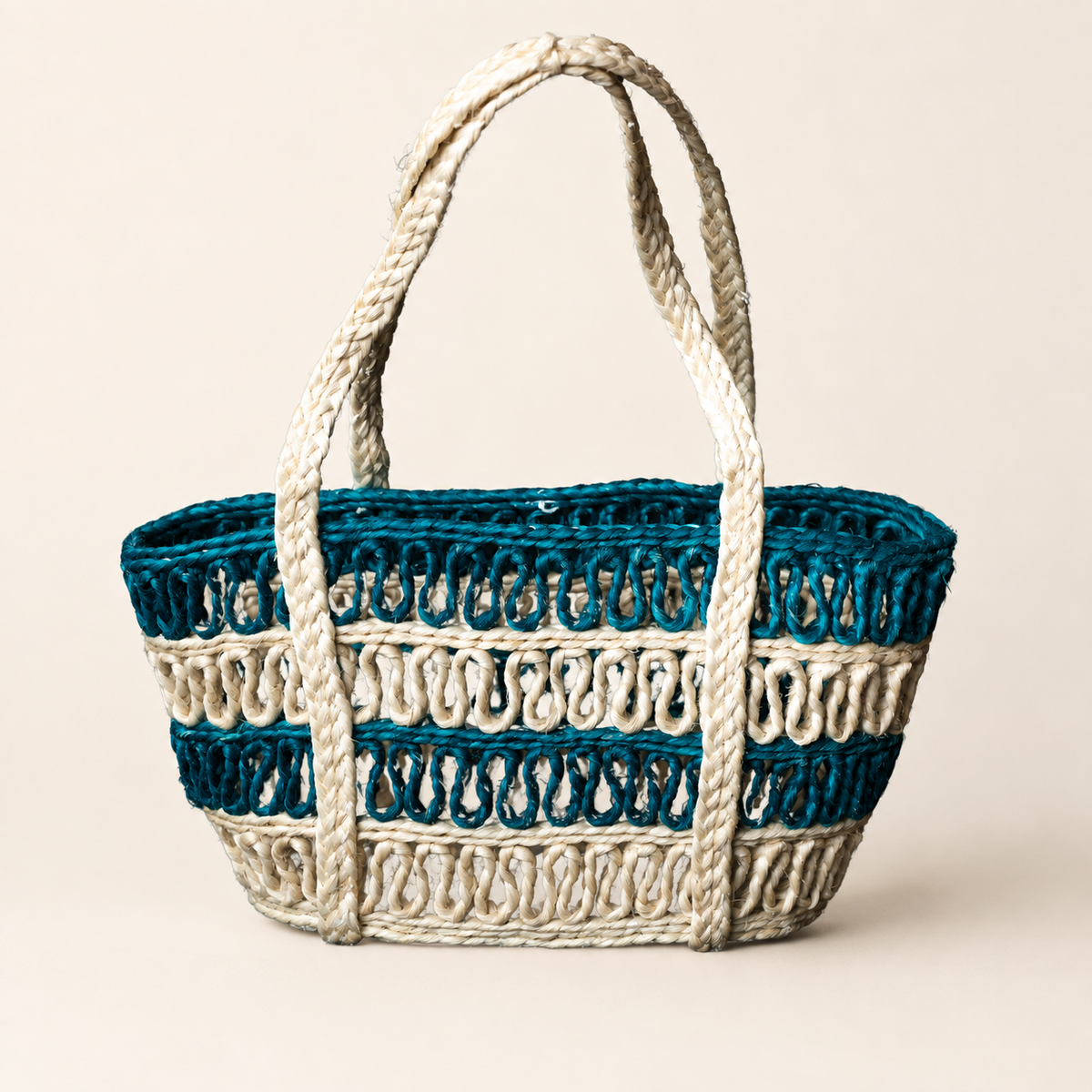 Teal and natural cream handcrafted sisal tote bag on a clean ivory studio background