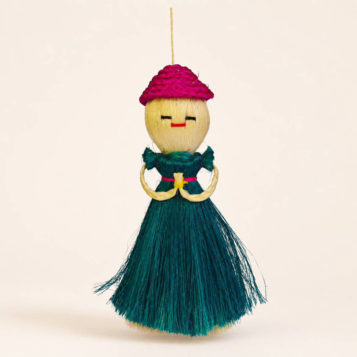 Handcrafted Bastar sisal doll on a clean warm ivory studio background