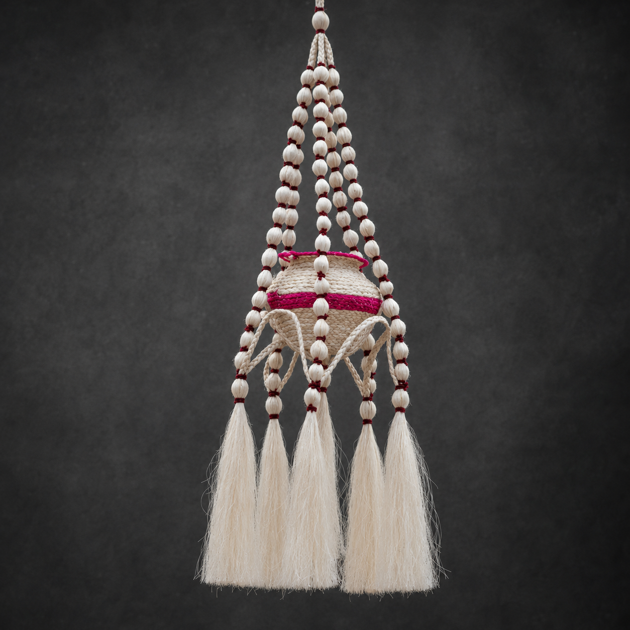 Detailed view of the braided sisal, beaded strands and tassels of a hanging planter