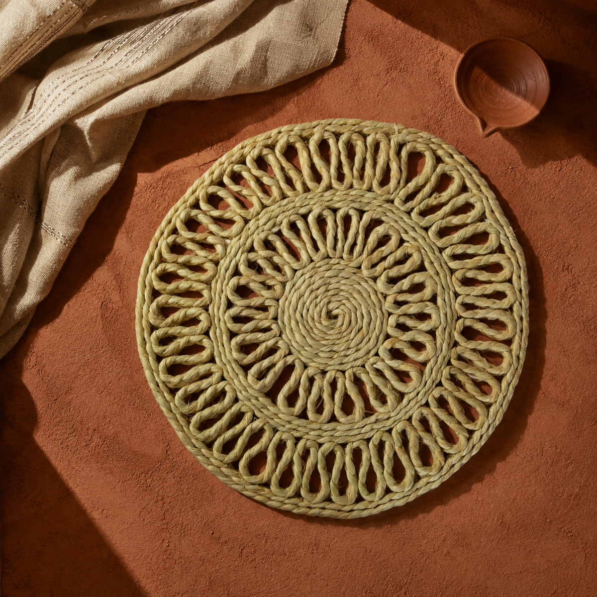 Bastar handcrafted sisal table mat displayed in a warm terracotta craft editorial setting