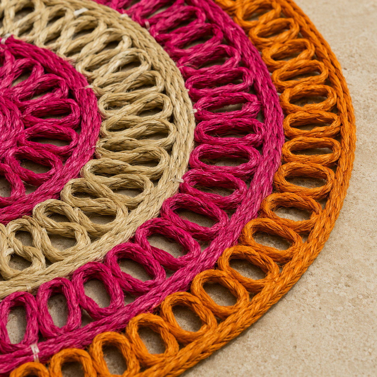 Close detail of the magenta, natural beige, and orange looped sisal fibre weave