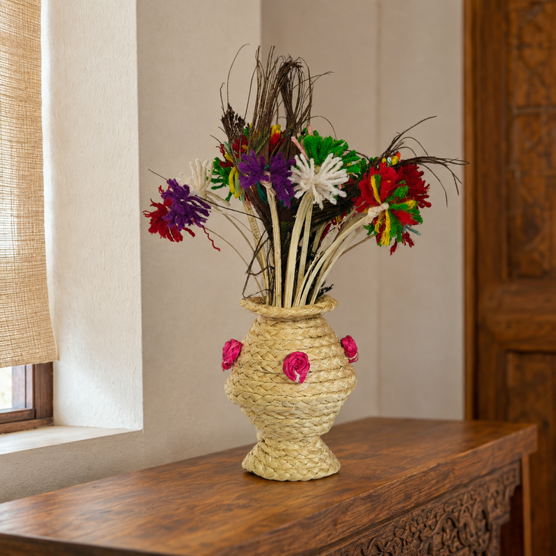 Bastar sisal table vase with colourful fibre flowers displayed on a carved wooden console