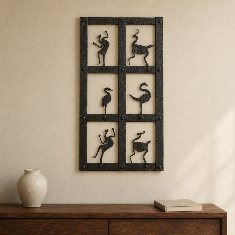 Bastar wrought iron tribal dance wall panel mounted above a walnut console