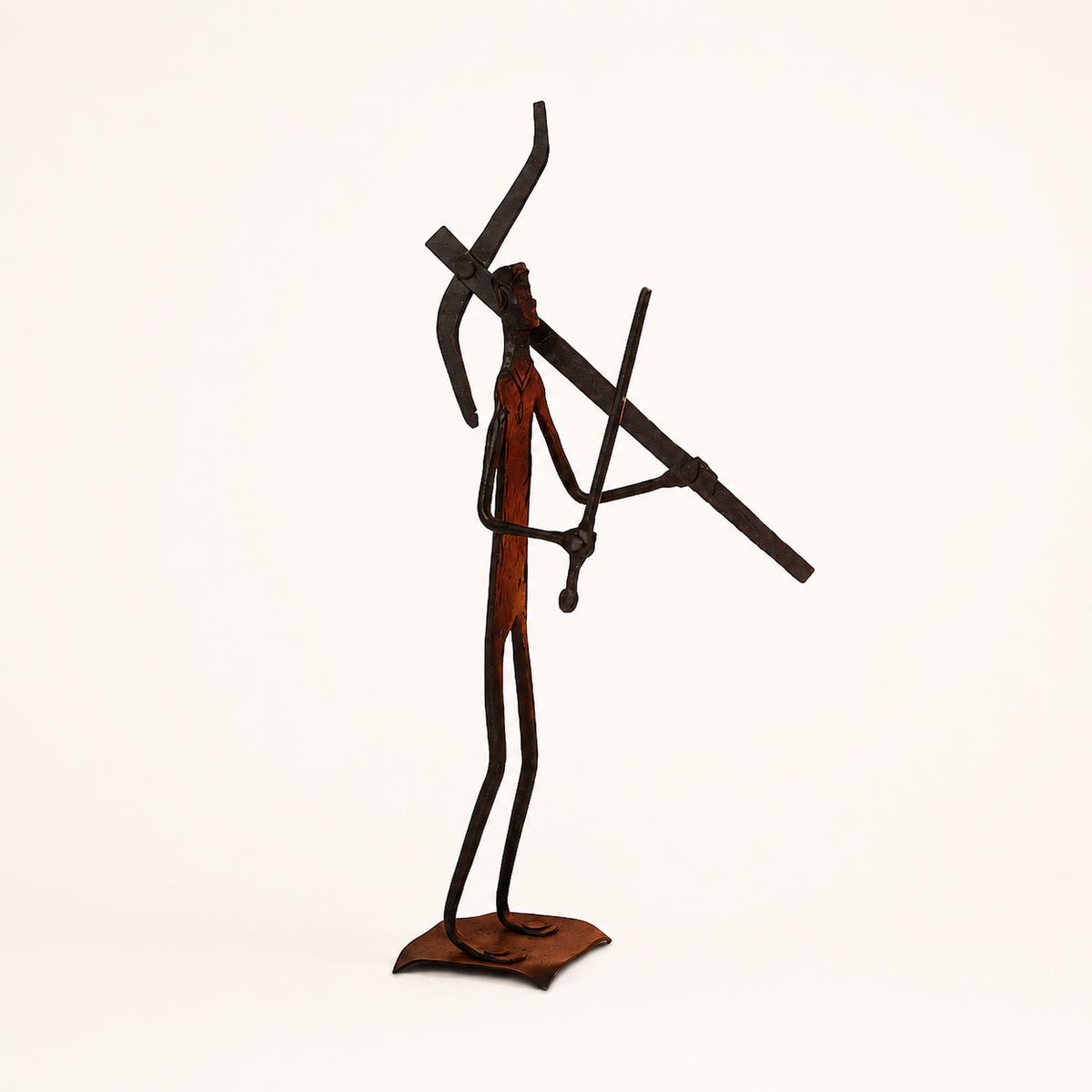 Bastar wrought iron tribal hunter-warrior sculpture on a warm studio background