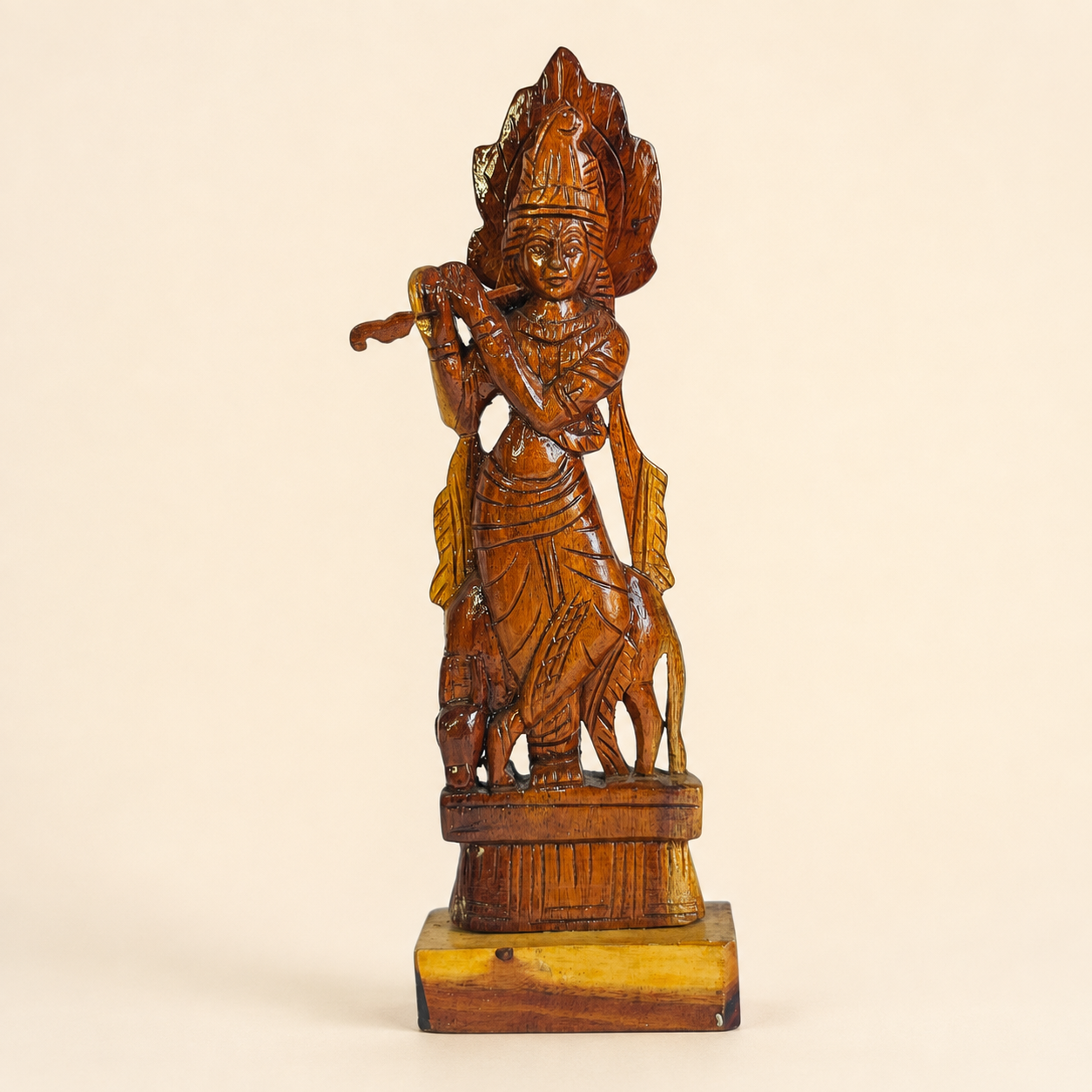 Hand-carved Bastar wooden Krishna statue with flute on a clean ivory studio background