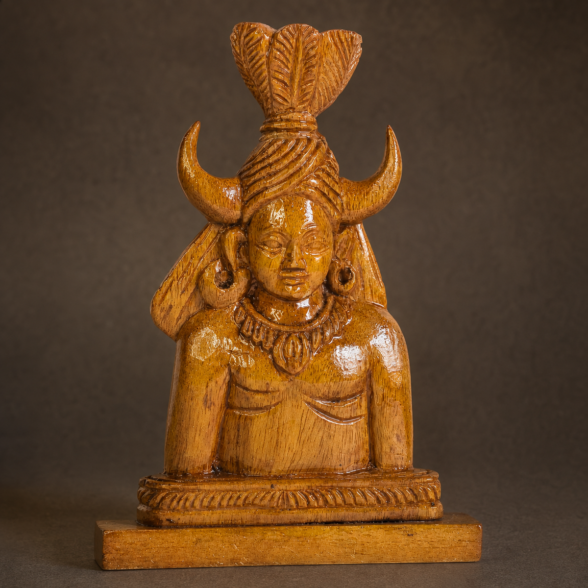 Craft detail of the horned headdress, jewellery, wood grain, and carved base of a Bastar Madia sculpture