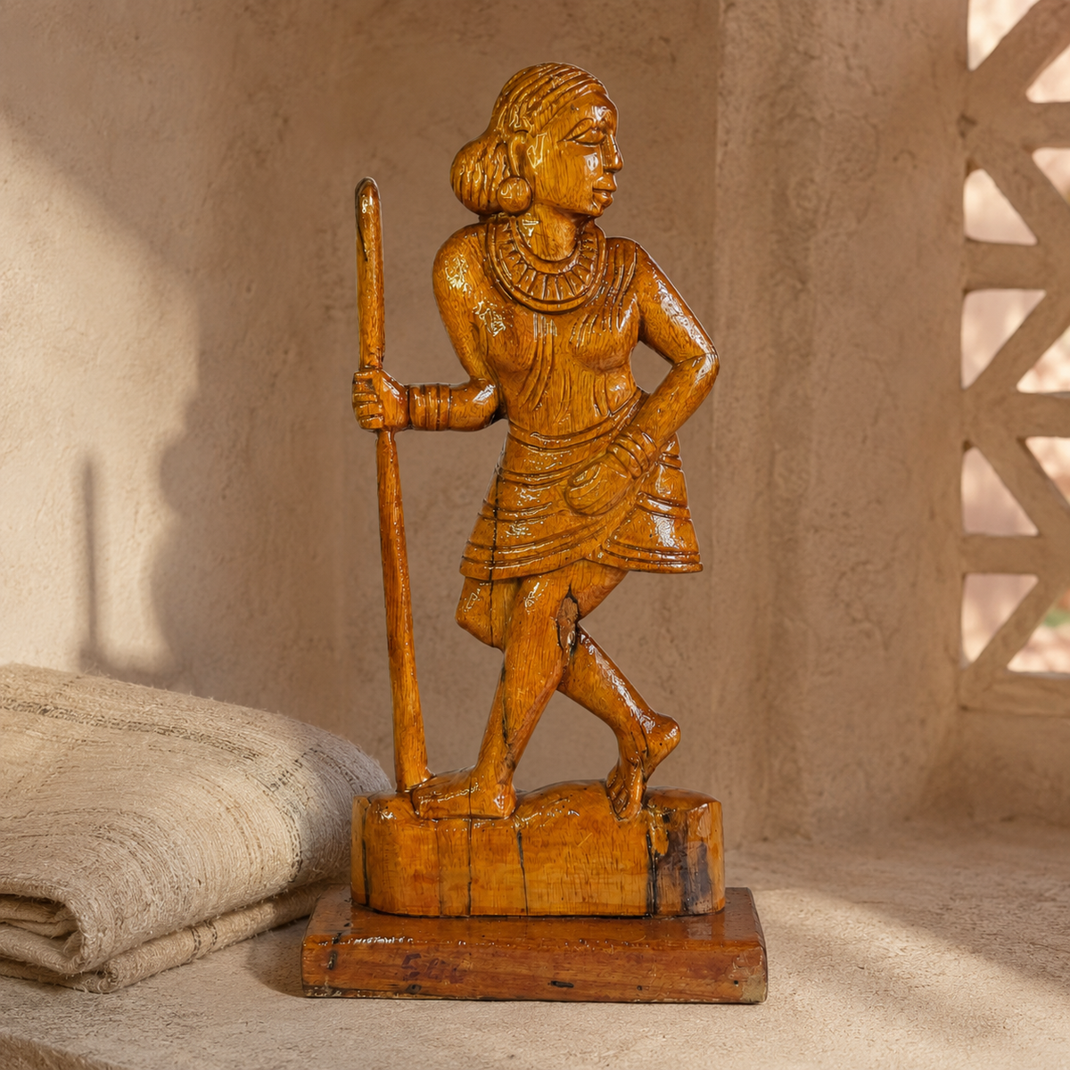 Hand-carved Madin woman sculpture in a warm Bastar-inspired editorial setting
