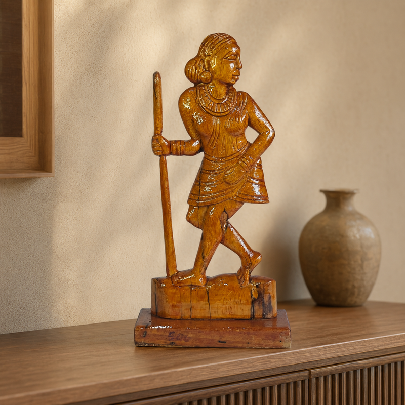 Bastar wooden Madin tribal woman sculpture displayed on a warm living-room console