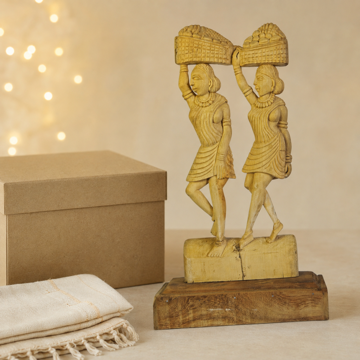 Bastar tribal women wooden sculpture presented beside a kraft gift box and handloom cloth