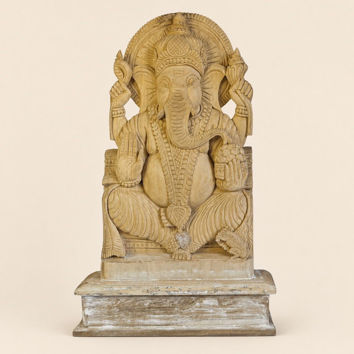 Hand-carved Bastar wooden Ganesh statue on a clean ivory studio background