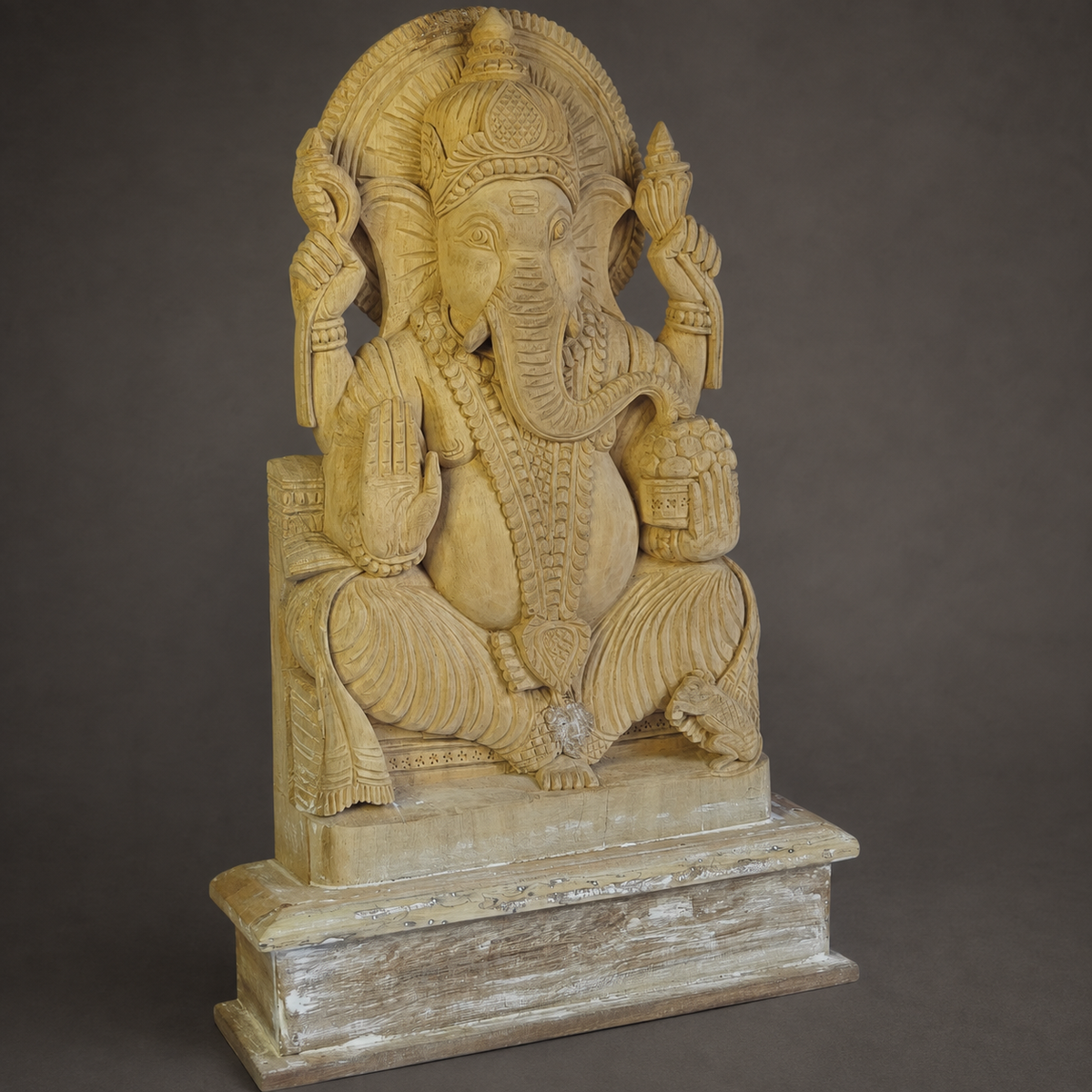 Close craftsmanship view of the crown, trunk and carved details on a wooden Ganesh statue