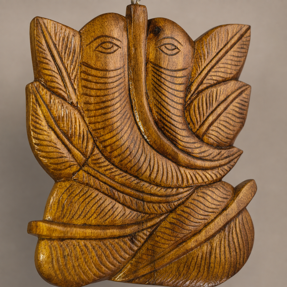 Close craftsmanship view of the wood grain and carved grooves on a Bastar Ganesha wall hanging