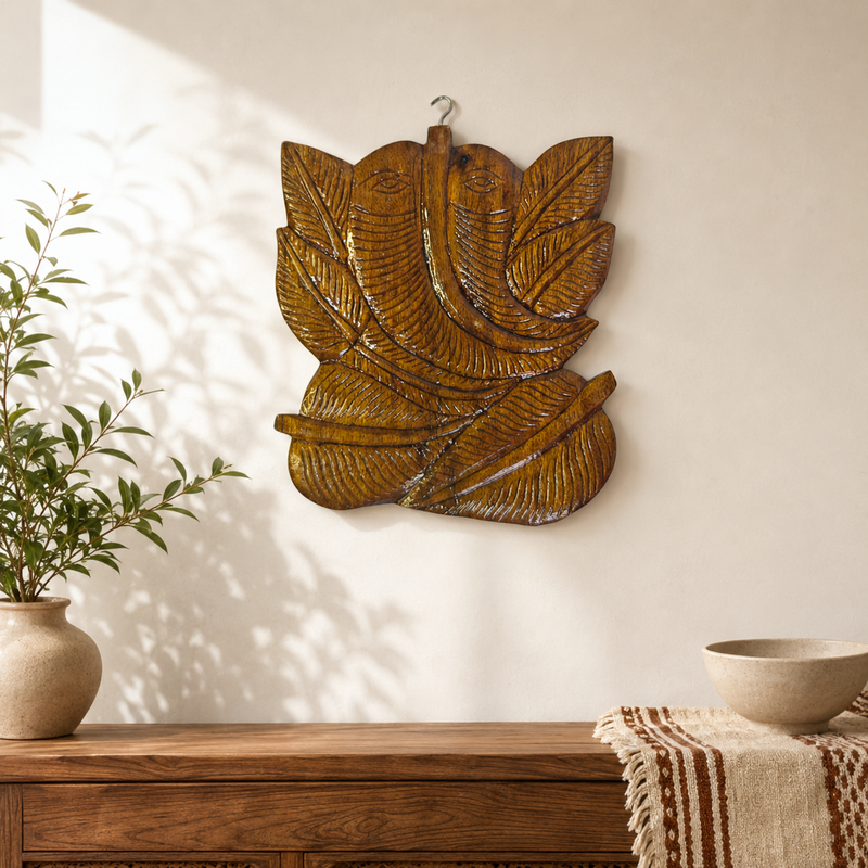 Bastar wooden Ganesha wall hanging displayed above a console in a warm entryway