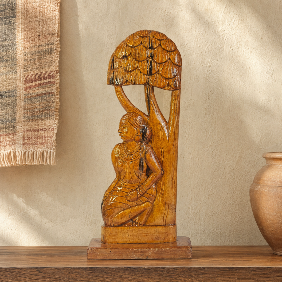 Hand-carved Bastar Madin woman sculpture displayed on a wooden console in a warm interior