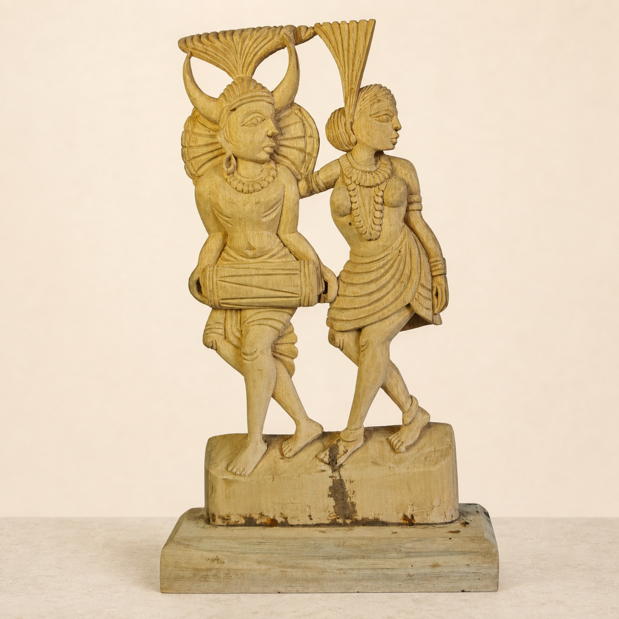Hand-carved Bastar Madia-Madin musician couple sculpture on a warm ivory catalogue background