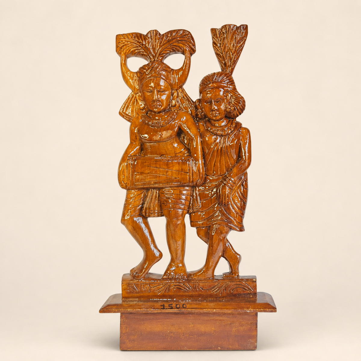 Bastar wood-carved Madia-Madin musician couple sculpture on a warm ivory studio background