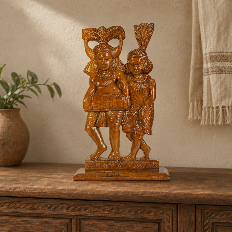 Bastar wood-carved musician couple sculpture displayed on a wooden console in a warm interior