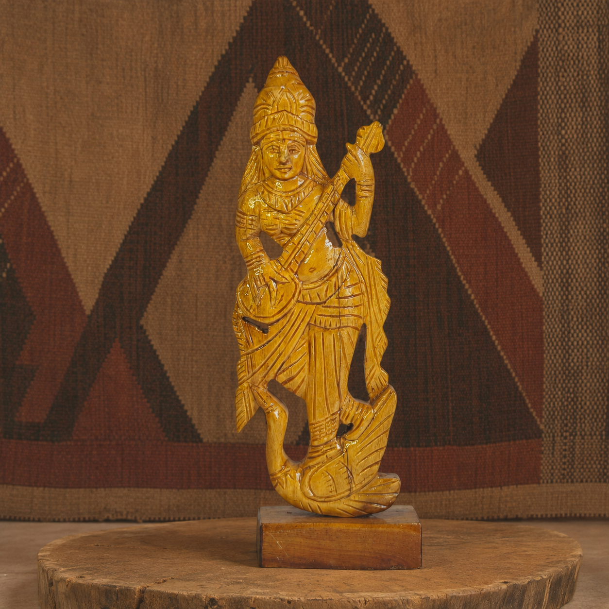 Hand-carved wooden Goddess Saraswati statue in an earth-toned Bastar craft setting