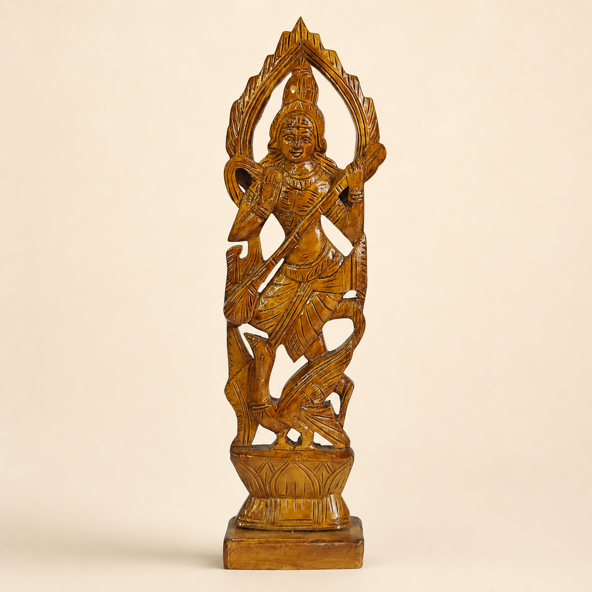 Hand-carved Bastar wooden Goddess Saraswati statue on a clean ivory studio background