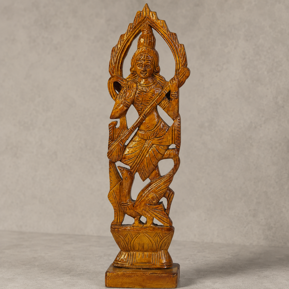 Craft detail of the carved arch, veena, swan and wood grain on a Saraswati statue