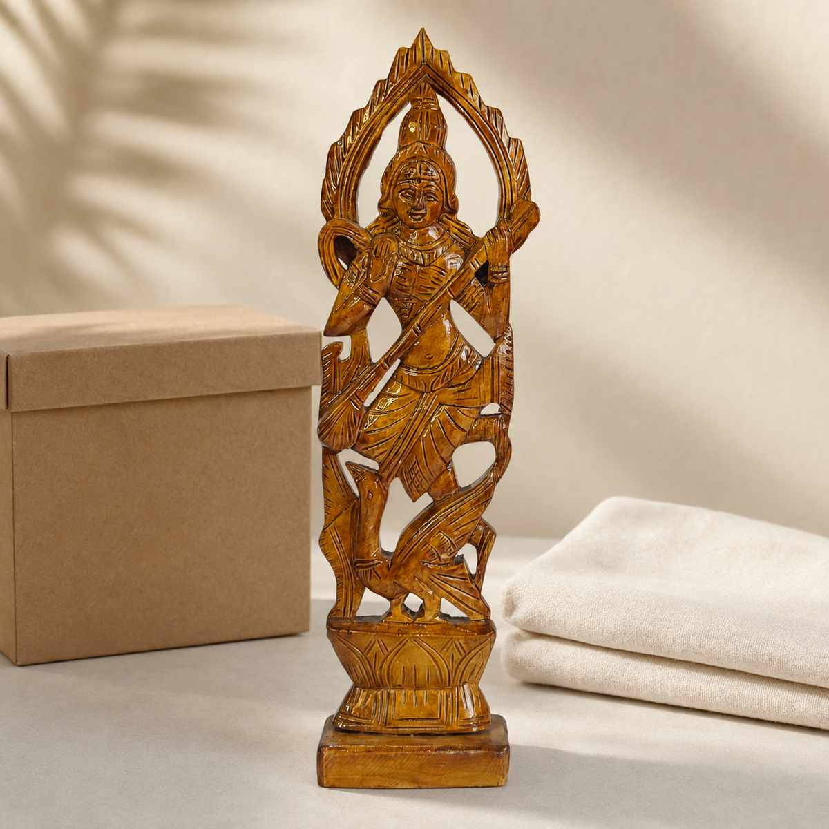 Hand-carved wooden Saraswati statue presented as a meaningful gift