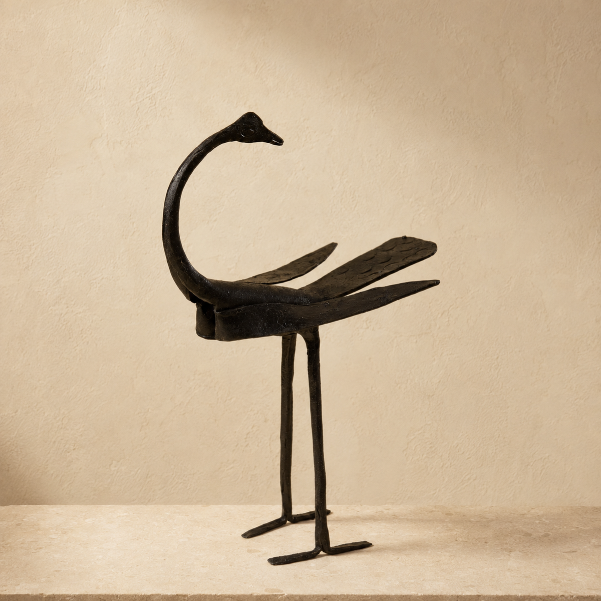 Bastar Wrought Iron Crane Statue on a warm ivory stone pedestal
