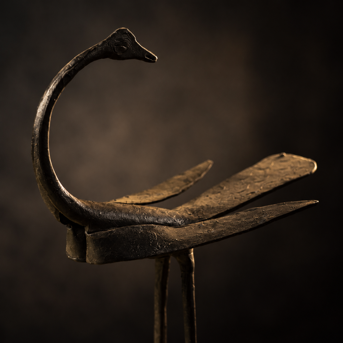 Close-up of the hand-forged neck and layered wings of the crane statue