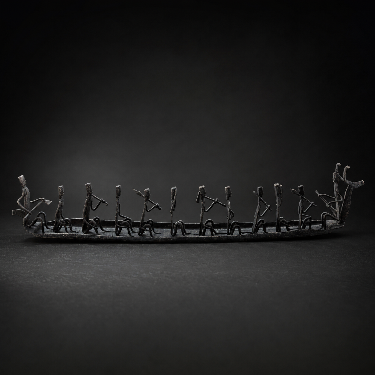 Detailed view of the hand-forged musicians and ironwork on the tribal boat