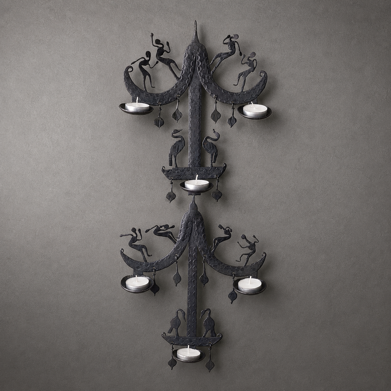 Craft detail of a hammered Bastar iron wall holder with dancers, birds and pendants