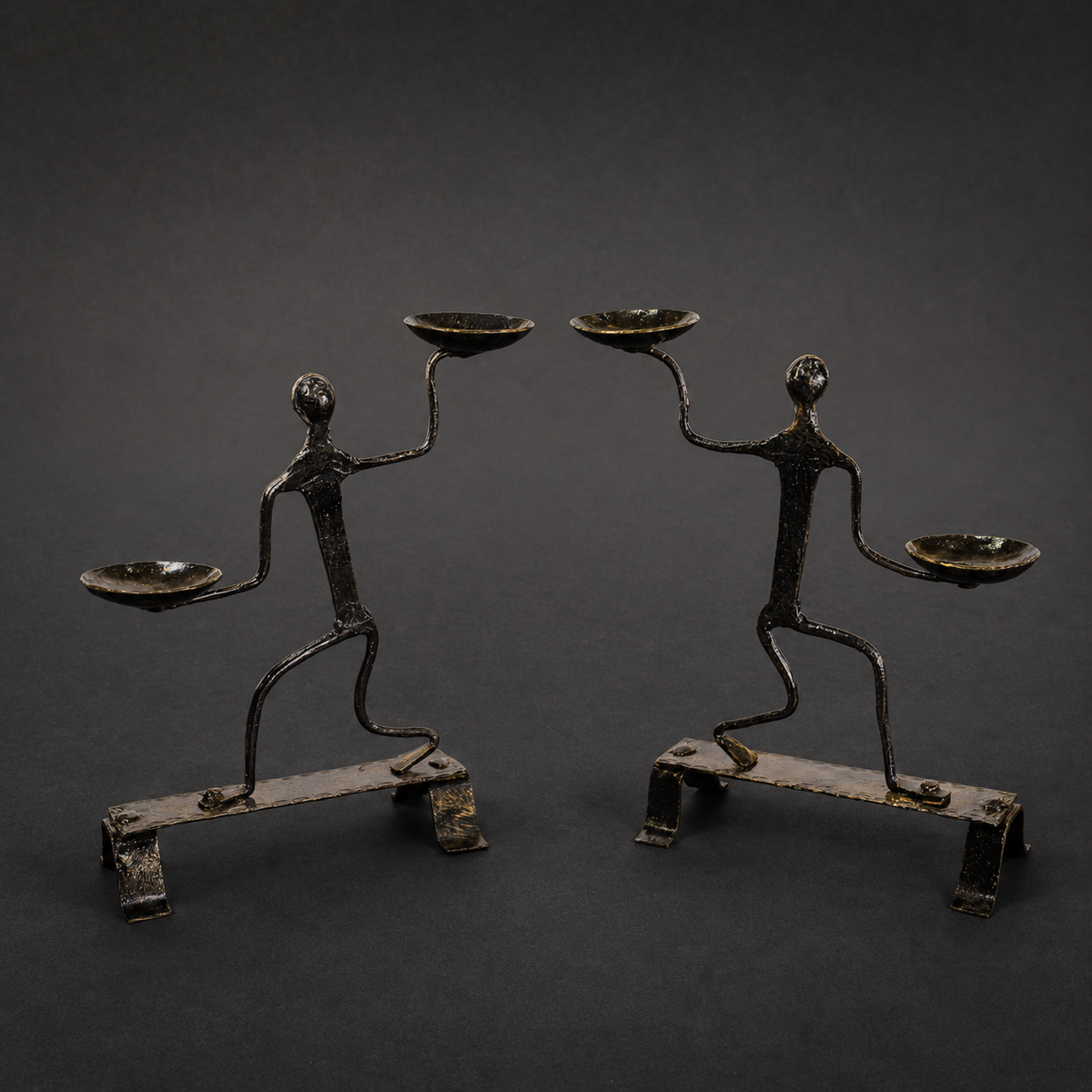 Craft detail of forged dancing figures, four bowls, bases and iron patina