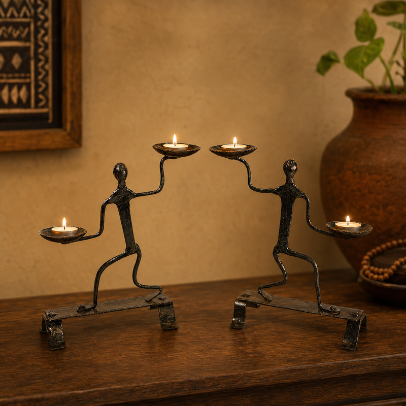 Bastar wrought iron dancing figure candle holders with four lit tealights in a warm interior