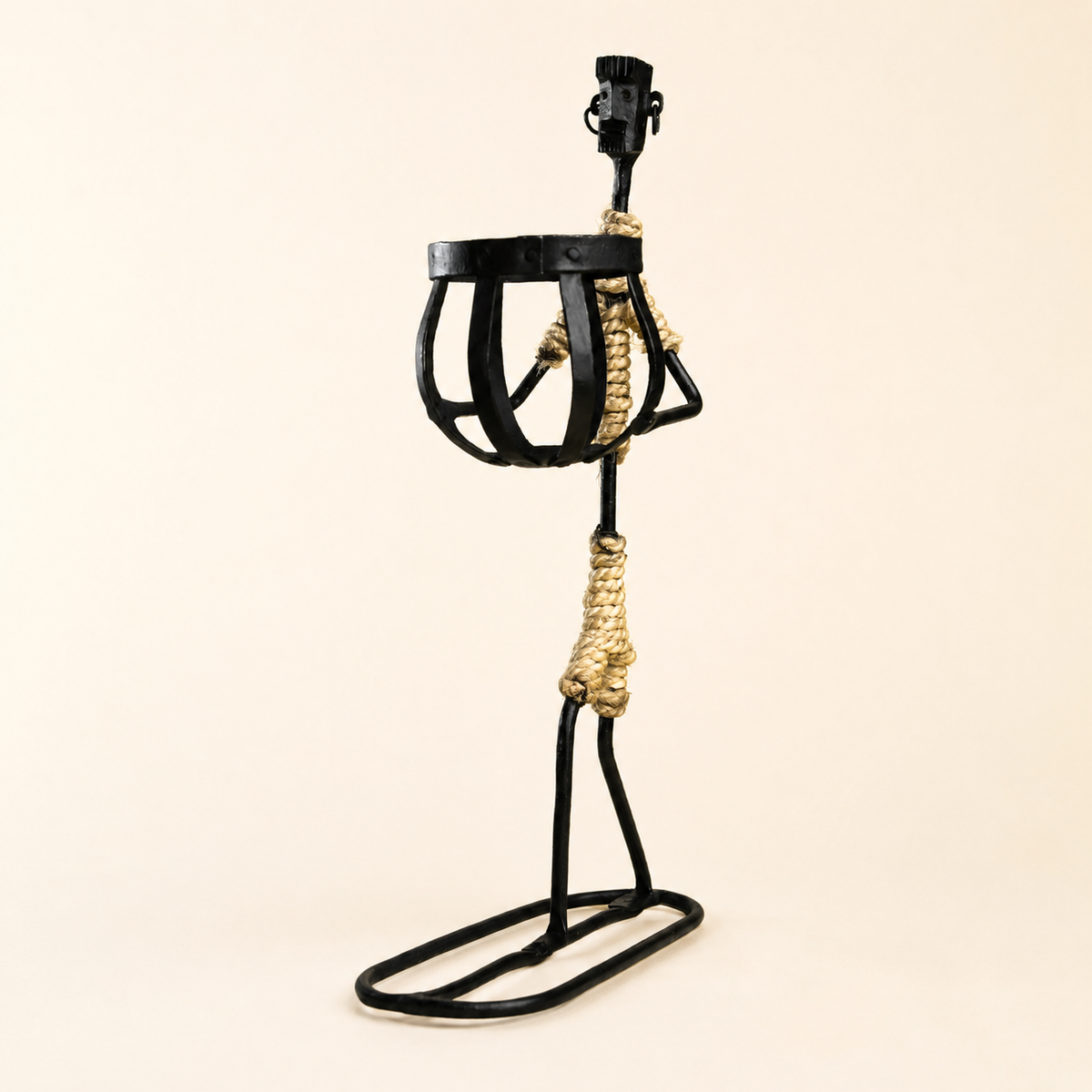 Bastar wrought iron tribal candle holder with rope wrapping on a warm ivory studio background