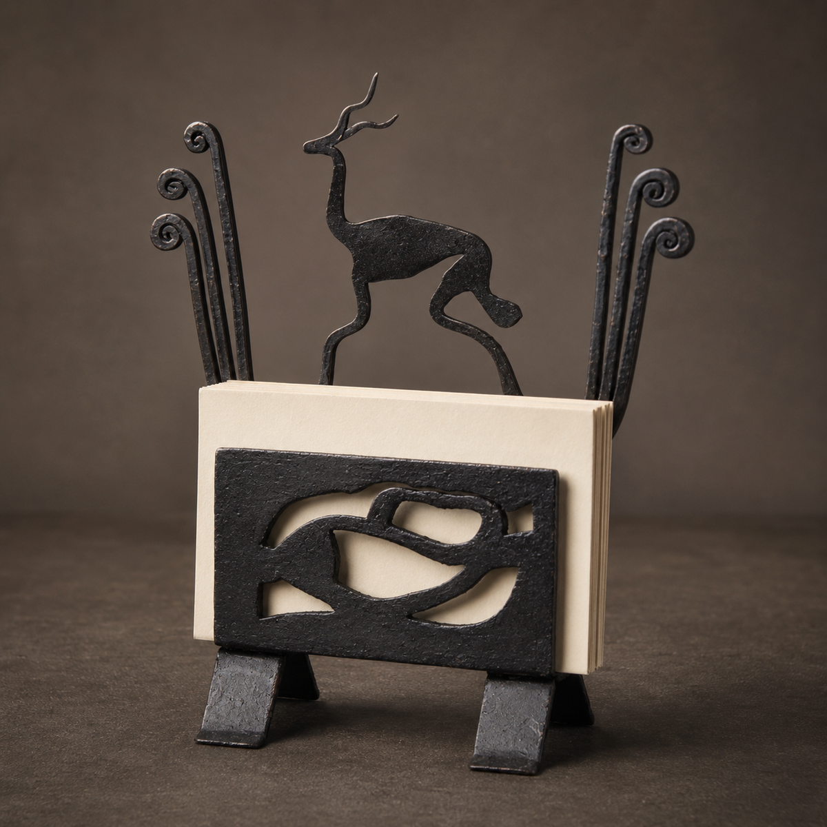 Detailed studio view of the hand-forged deer card holder and curled iron stems