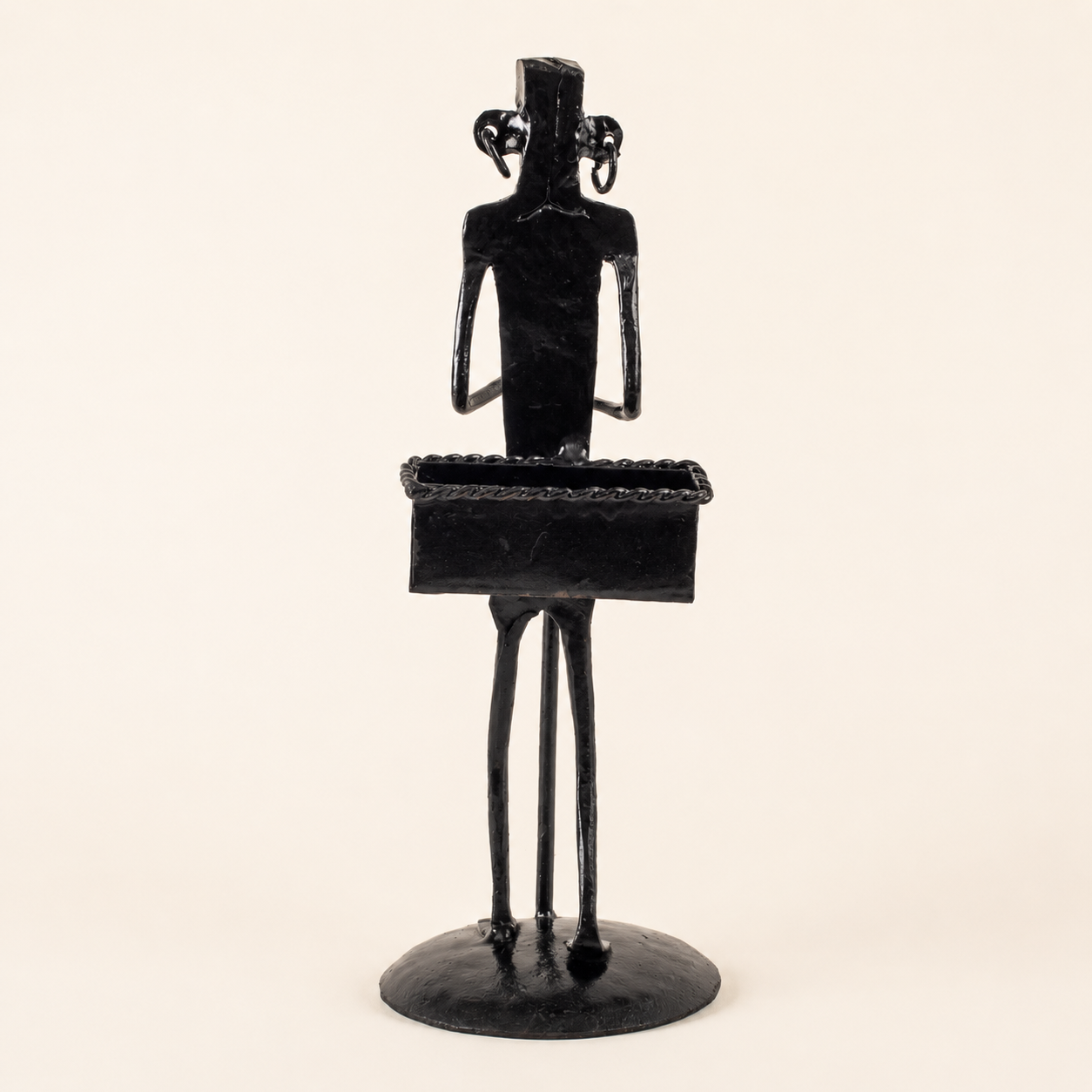 Bastar wrought iron tribal figure card holder on a warm ivory catalogue background