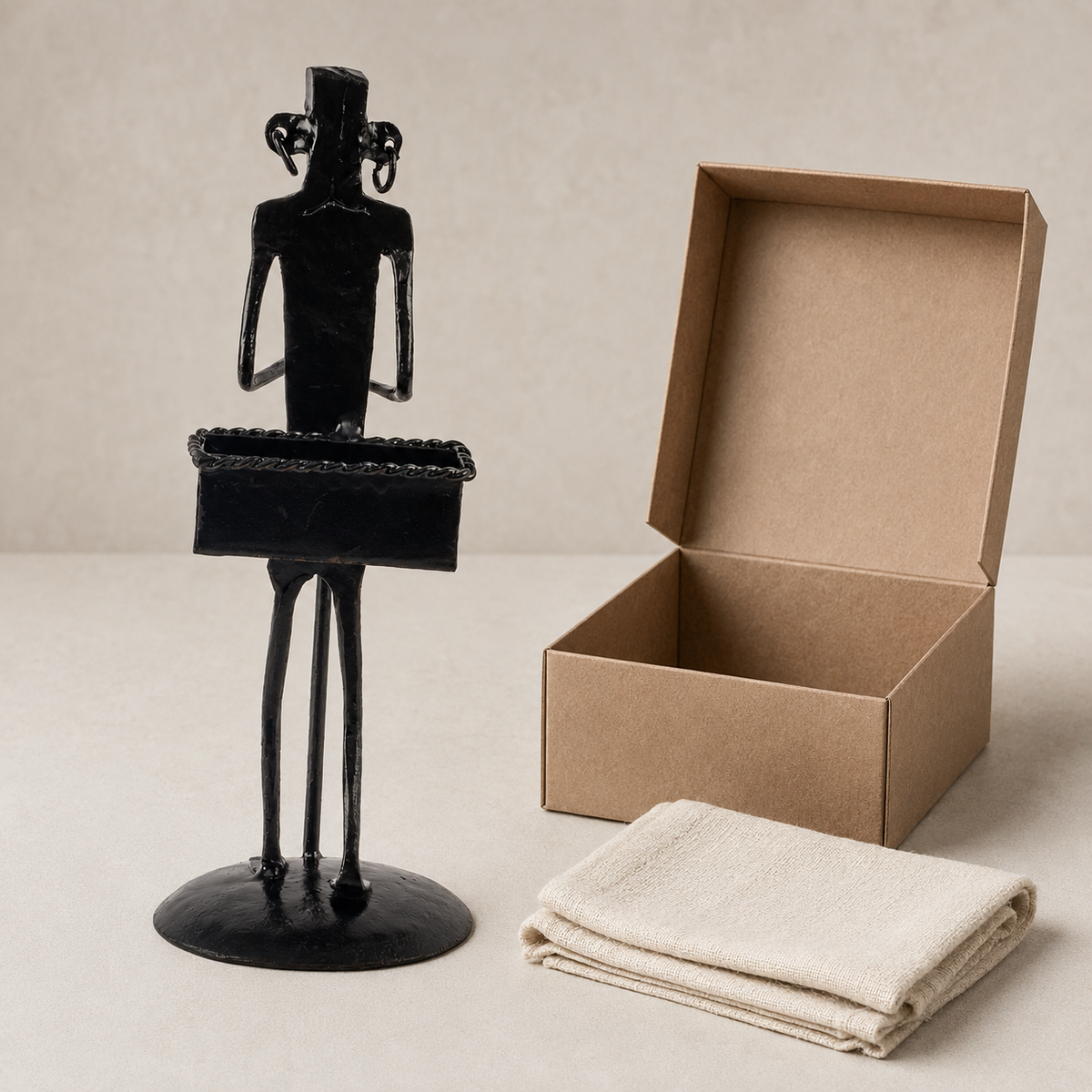 Bastar wrought iron tribal figure card holder displayed beside an open gift box