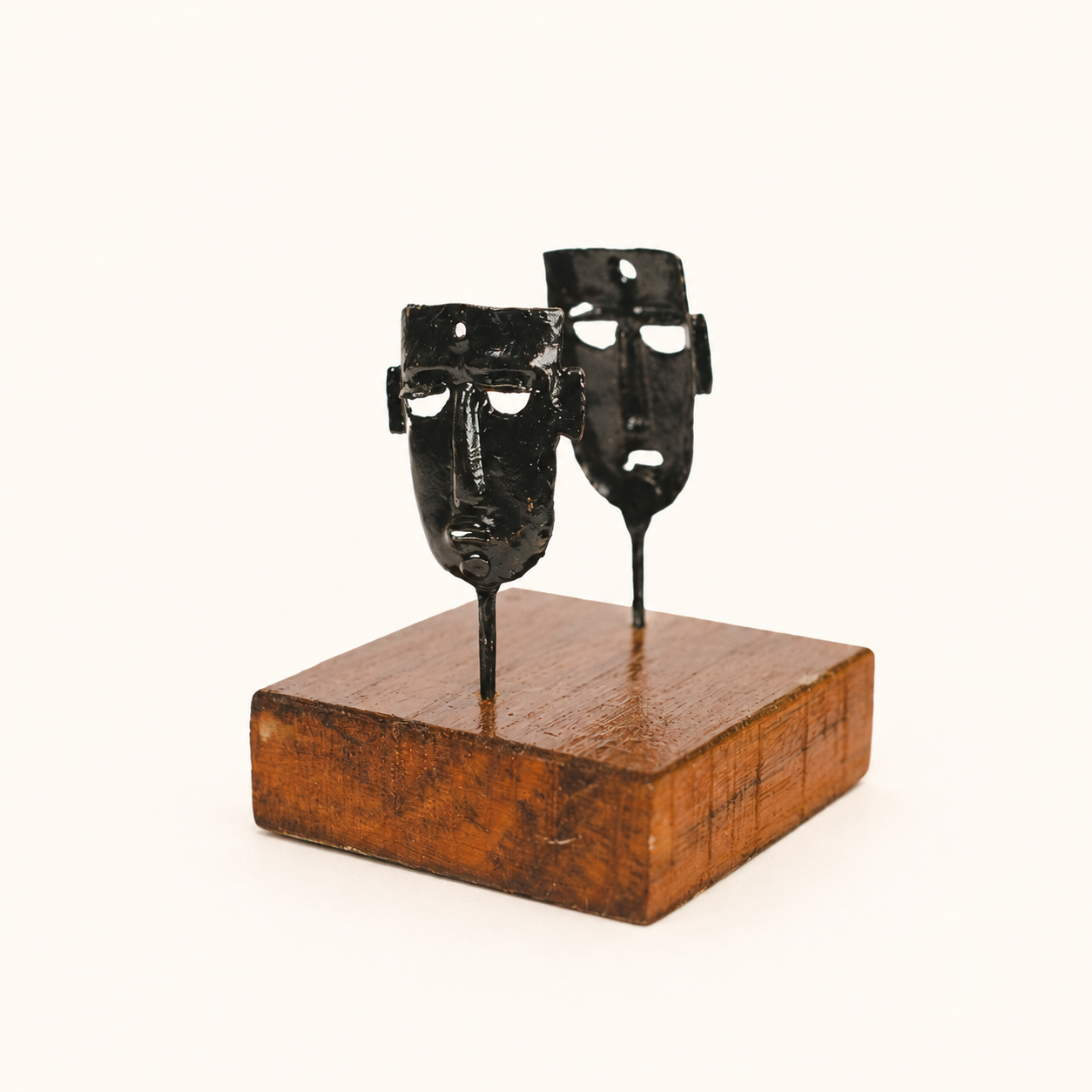 Bastar wrought iron two-mask card holder on a warm ivory catalogue background