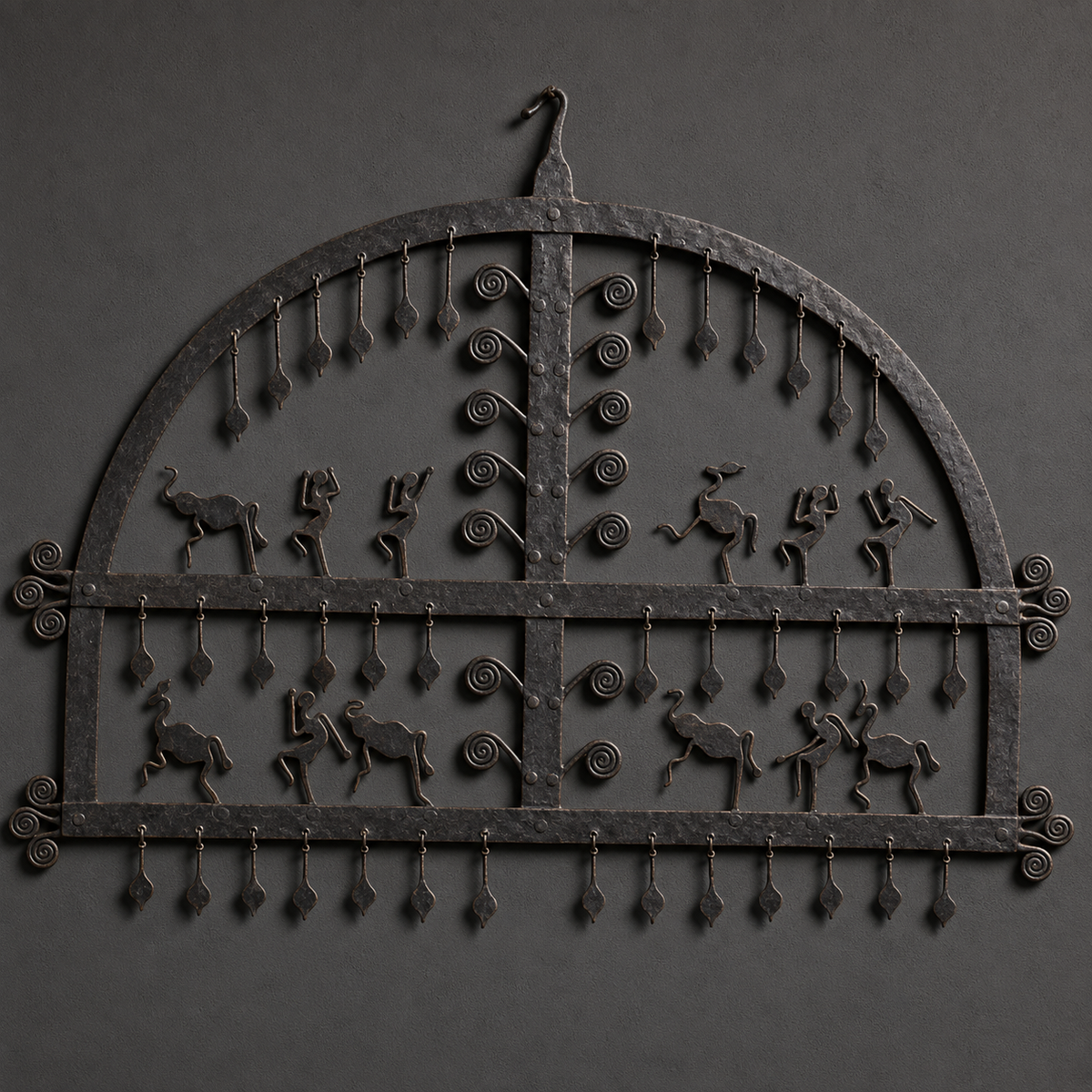 Detailed view of animal, dancer, spiral and pendant metalwork on a Bastar iron frame