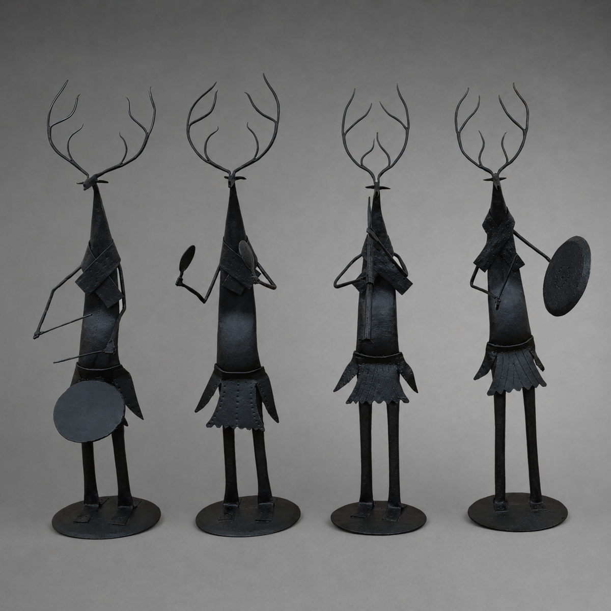 Craft detail of four forged iron deer musicians with antlers and traditional instruments
