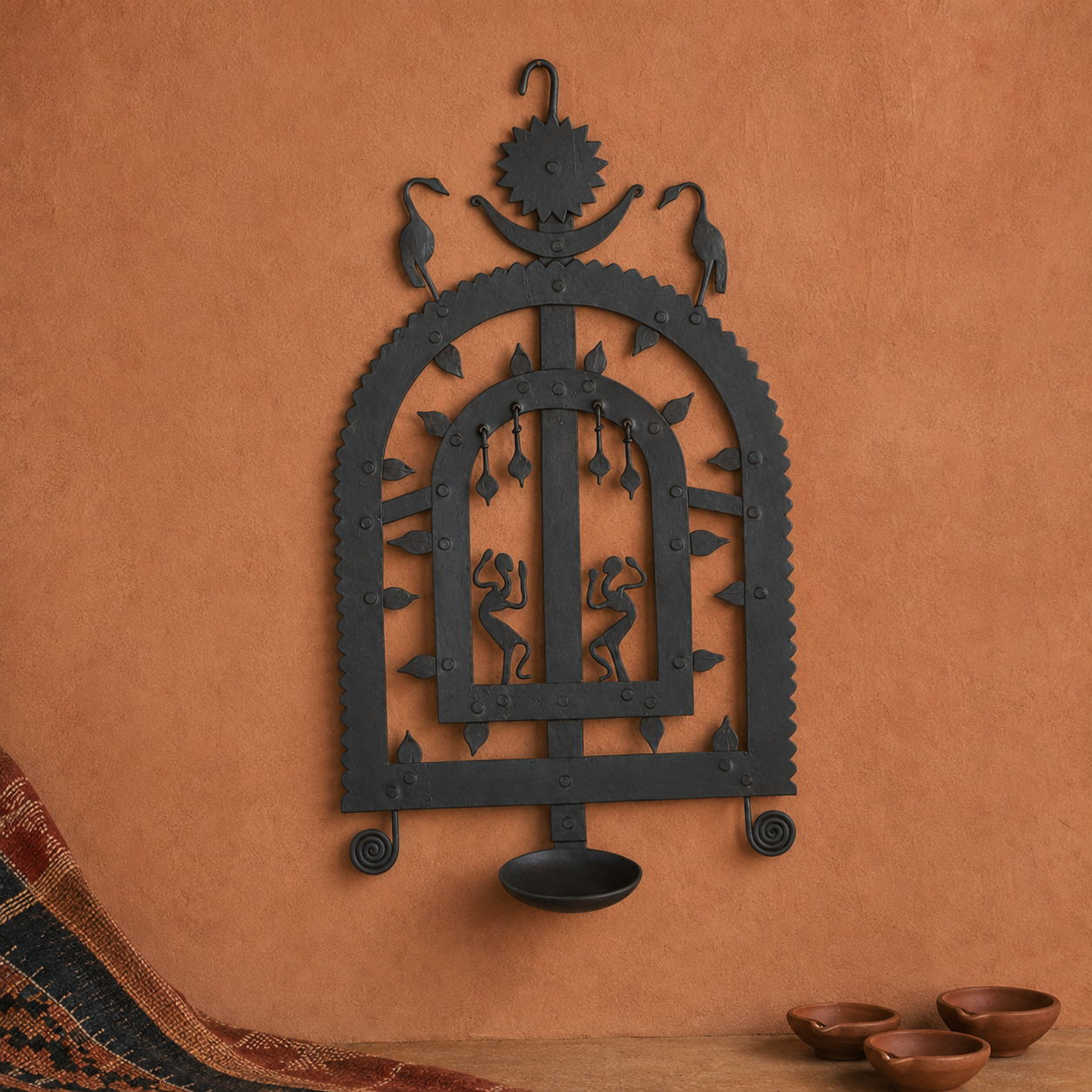 Bastar wrought iron diya wall frame Design 2 in an earthy craft editorial setting