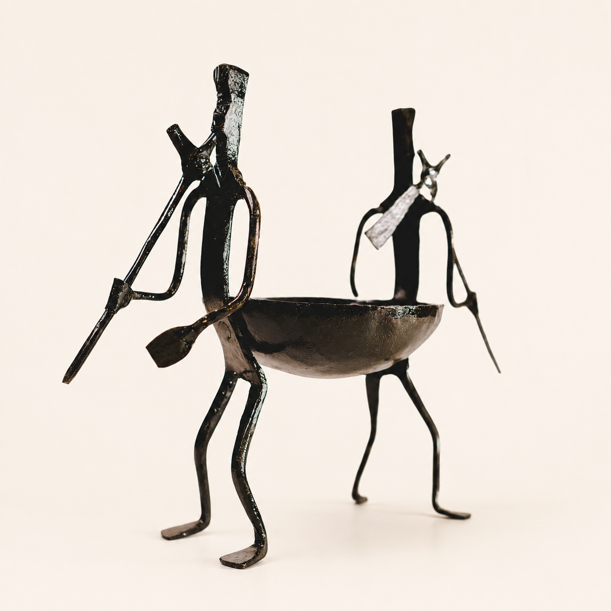 Bastar wrought iron dry fruit holder with two tribal figures and a shallow bowl on ivory