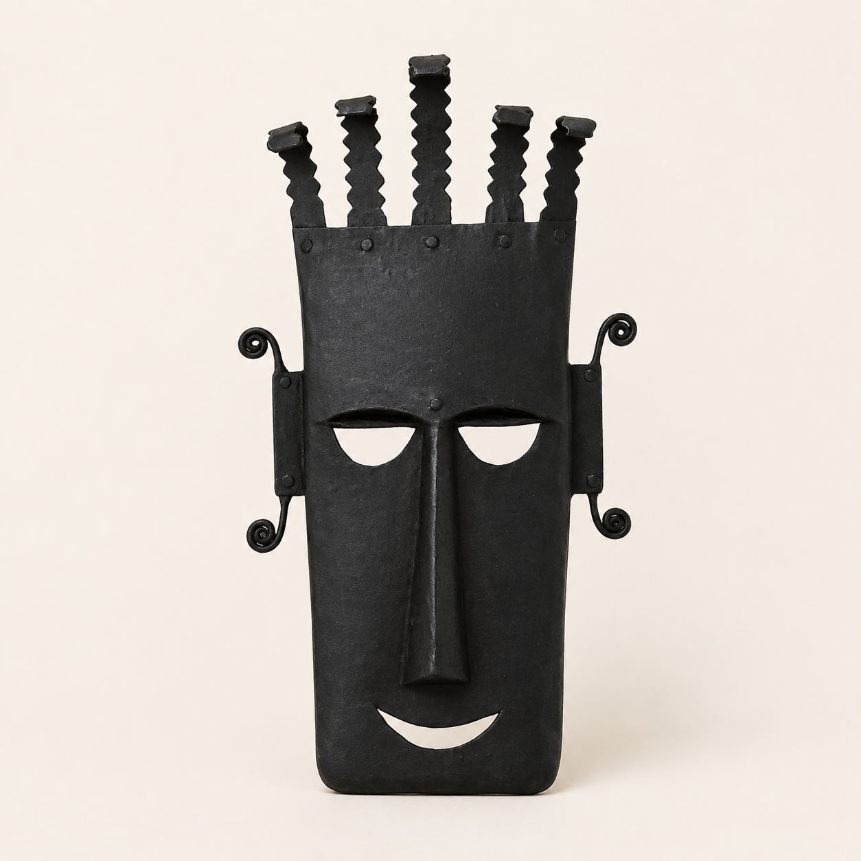 Black Bastar wrought iron face mask with five-prong crown on an ivory background