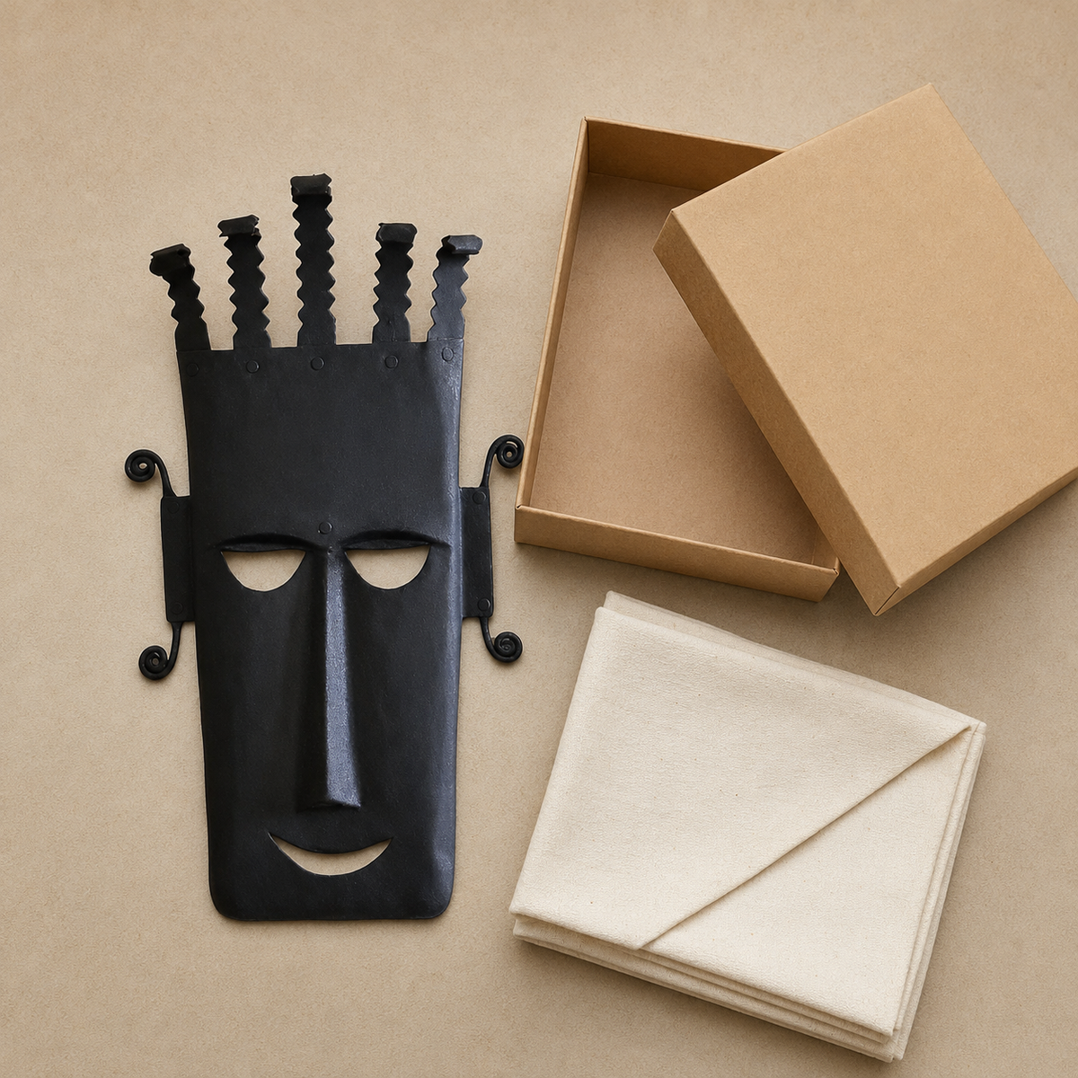 Bastar wrought iron five-crown face mask displayed with an open gift box