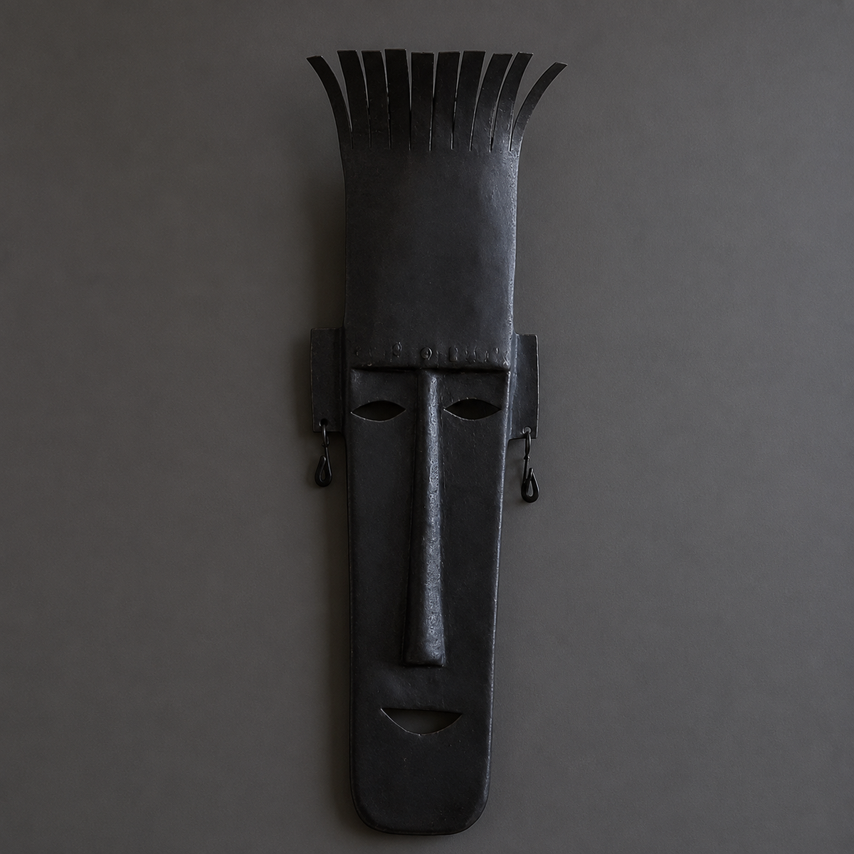 Detailed view of the crown strips, rivets, cutouts and patina of a Bastar iron mask