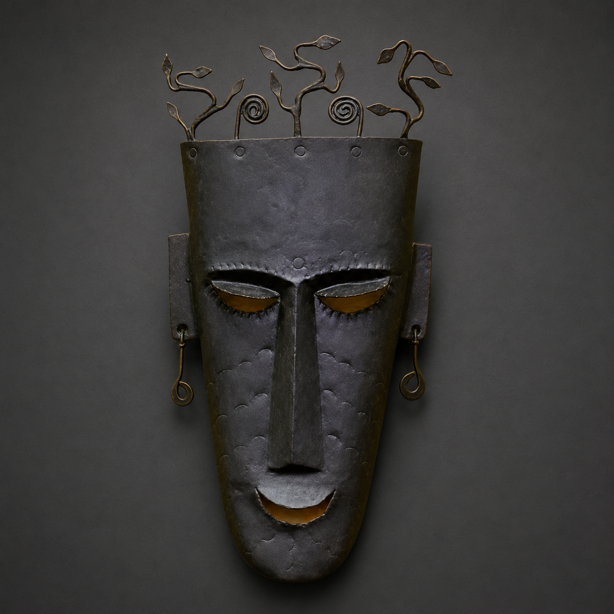 Detailed view of the forged vines, rivets, facial features and hammered iron finish