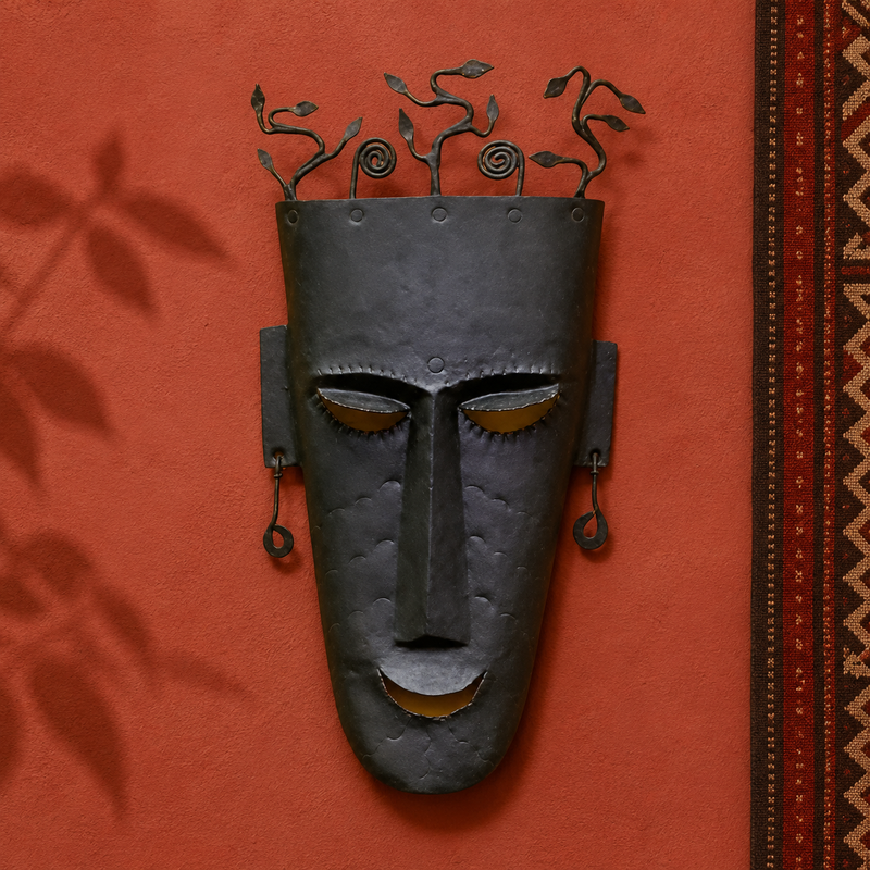 Hand-forged Bastar face mask presented on an ochre artisan gallery wall