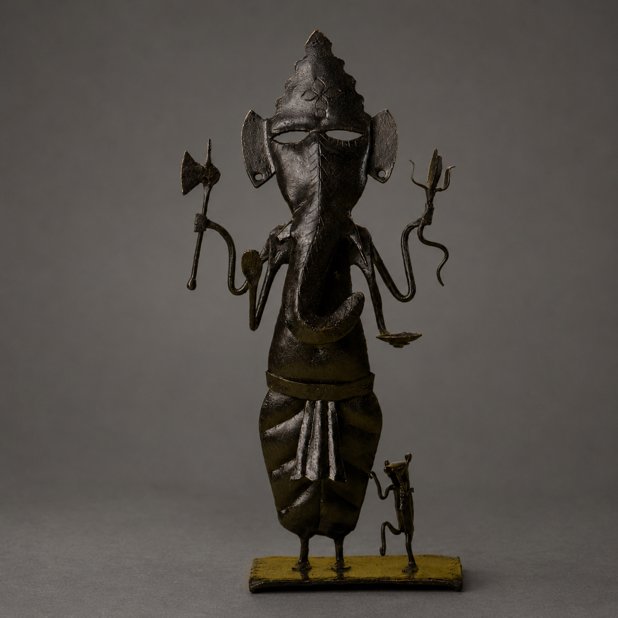 Detailed view of the crown, trunk, attributes and patina of a Bastar iron Ganesh