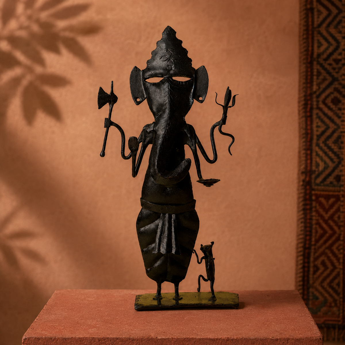 Bastar wrought iron Ganesh Ji displayed on an ochre artisan gallery plinth
