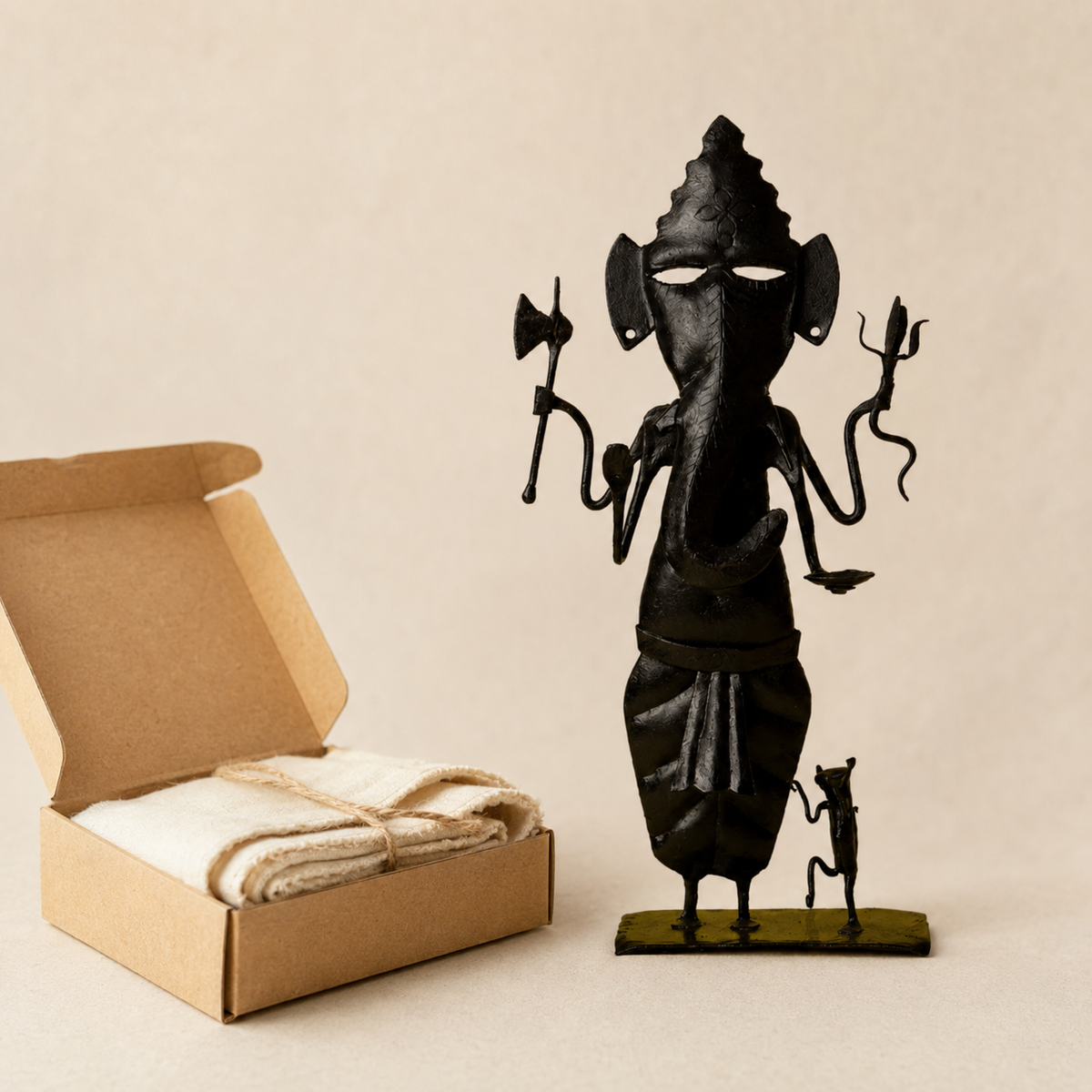Hand-forged Bastar wrought iron Ganesh Ji presented beside an open kraft gift box