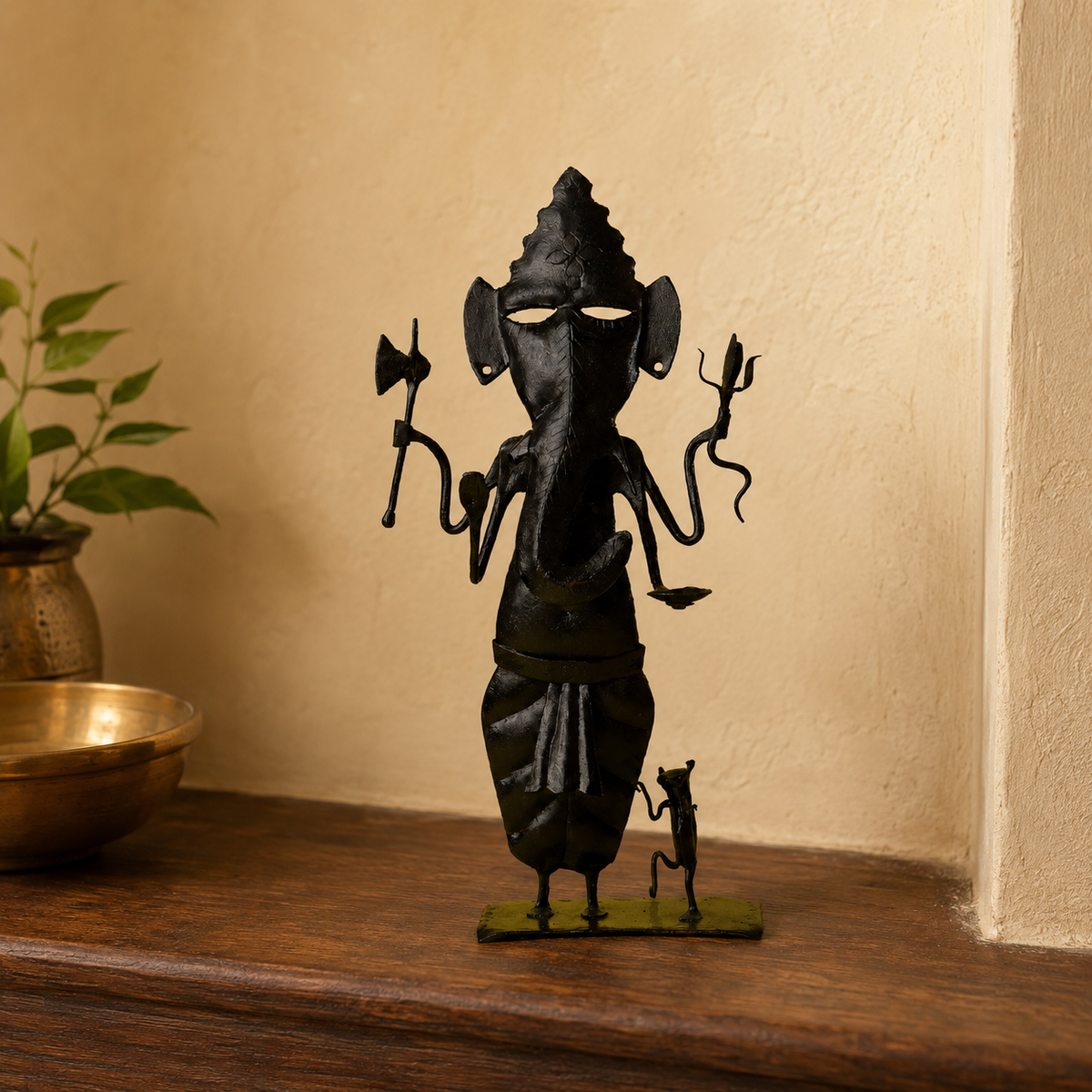 Hand-forged Bastar Ganesh sculpture displayed in a warm Indian home niche